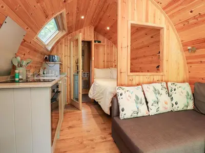 a kitchen and a bedroom in a tiny house at Homewood Pod in Preston