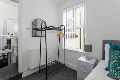 a bedroom with a bed and a window at Woodbine House - Air Host and Stay - Free parking - Contractor Friendly in Liverpool