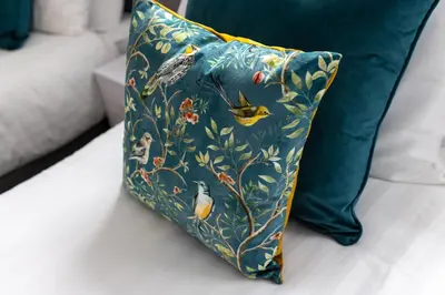 a blue pillow with birds on it on a bed at Woodbine House - Air Host and Stay - Free parking - Contractor Friendly in Liverpool