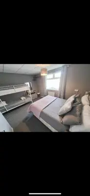 a bedroom with a bed with pillows and a window at The Montclair in Blackpool
