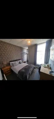 a hotel room with a bed and a window at The Montclair in Blackpool
