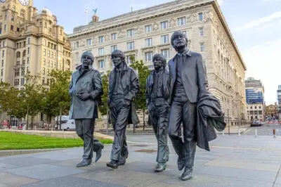a statue of four men walking in front of a building at Cheerful 2 Bedroom Home with Off-road parking in Deysbrook