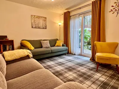 a living room with a couch and a window at Cheerful 2 Bedroom Home with Off-road parking in Deysbrook