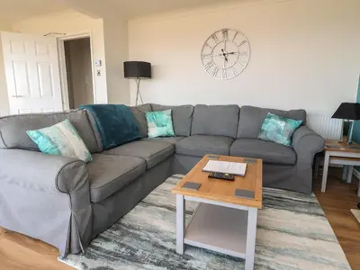 a living room with a couch and a table at Flat 3, Sandridge Court in Fleetwood