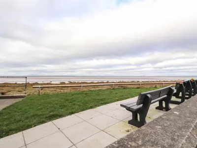a row of park benches overlooking the ocean at Flat 3, Sandridge Court in Fleetwood