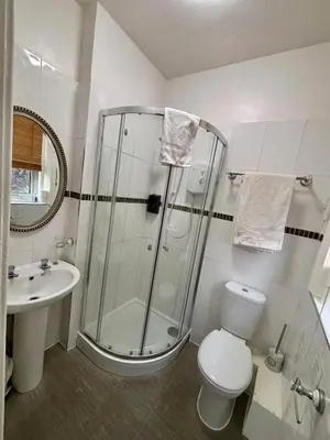 a bathroom with a shower and a toilet and a sink at Lee & Chris's Belvedere - Adults Only in Blackpool