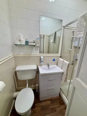 a bathroom with a toilet and a sink and a shower at Lee & Chris's Belvedere - Adults Only in Blackpool