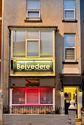 a building with a beehive sign in front of a store at Lee & Chris's Belvedere - Adults Only in Blackpool