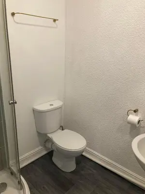 a bathroom with a white toilet and a sink at The New Astoria Hotel in Blackpool