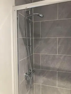 a shower with a glass door in a bathroom at The New Astoria Hotel in Blackpool