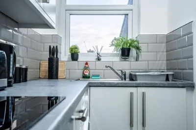 a kitchen with a sink and a window at Beautiful apartment dos - free public parking in Litherland