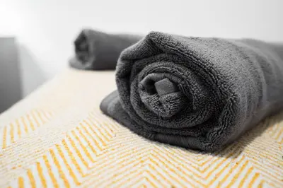 a pile of black towels sitting on a bed at Beautiful apartment dos - free public parking in Litherland