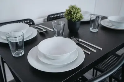 a black table with white plates and glasses on it at Beautiful apartment dos - free public parking in Litherland
