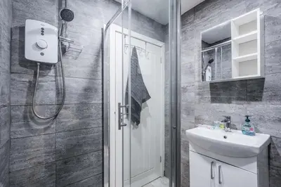 a bathroom with a shower and a sink at Beautiful apartment dos - free public parking in Litherland