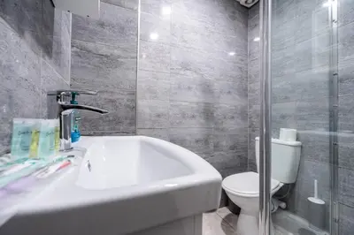 a bathroom with a white tub and a toilet at Beautiful apartment dos - free public parking in Litherland