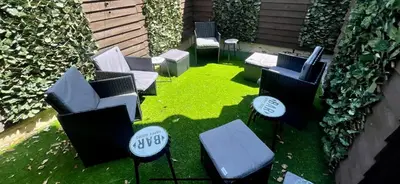 a group of chairs and tables on the grass at 4 bed 4 bath House with Free Parking, 5 Mins to LFC and 15 Mins to City Centre in Liverpool