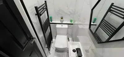 a white bathroom with a toilet and a sink at 4 bed 4 bath House with Free Parking, 5 Mins to LFC and 15 Mins to City Centre in Liverpool