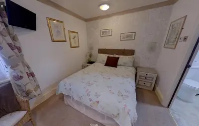 a small bedroom with a bed and a television at Fairhaven Palentine Road in Blackpool