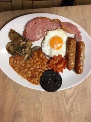 a plate of breakfast food with eggs beans and mushrooms at Fairhaven Palentine Road in Blackpool