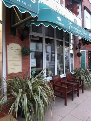 a store with two benches outside of a building at Fairhaven Palentine Road in Blackpool