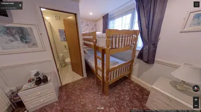 a small room with two bunk beds and a mirror at Fairhaven Palentine Road in Blackpool
