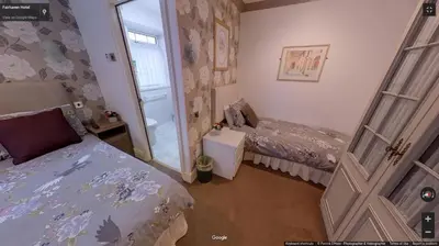 a bedroom with two beds and a door with a window at Fairhaven Palentine Road in Blackpool