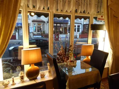 a table with two lamps in front of a window at Fairhaven Palentine Road in Blackpool