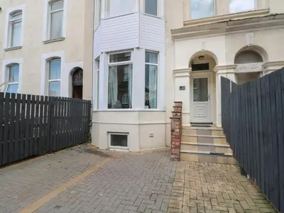 a house with a fence in front of it at Marine House in Southport