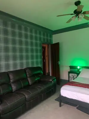 a living room with a couch and a bed at Family Holiday Home in Blackpool