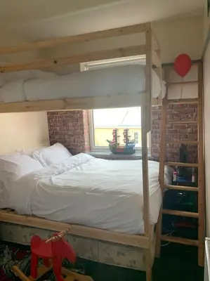 a bedroom with a bunk bed and a window at Family Holiday Home in Blackpool