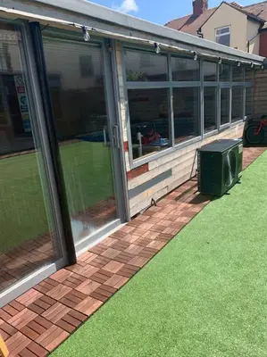a screened in porch with a television on the grass at Family Holiday Home in Blackpool