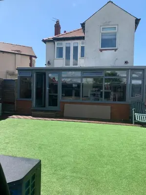 a house with a lawn in front of it at Family Holiday Home in Blackpool