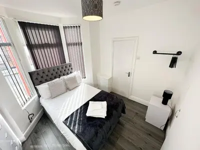 a small bedroom with a bed and a window at Vicar Road in Liverpool
