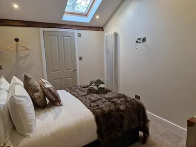 a bedroom with a bed with two stuffed animals on it at 8 Coach House in Preston