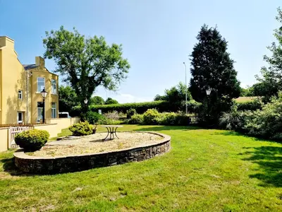 a garden with a bench in front of a house at 8 Coach House in Preston
