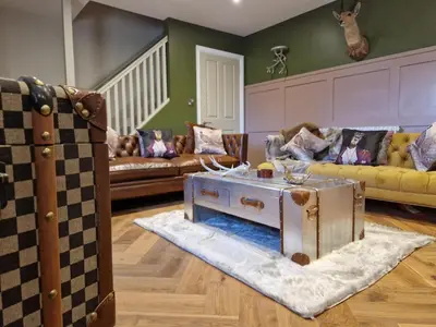 a living room with two couches and a table at 8 Coach House in Preston