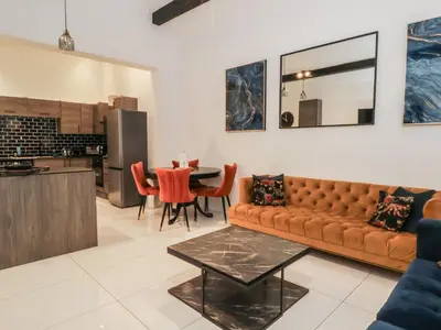 a living room with a couch and a table at 7 Holly Barn in Preston
