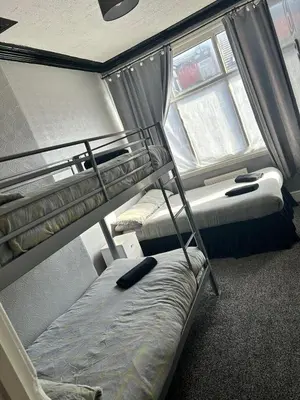 a bedroom with two bunk beds and a window at Adina Hotel in Blackpool