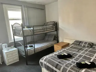 a bedroom with two bunk beds and a window at Adina Hotel in Blackpool