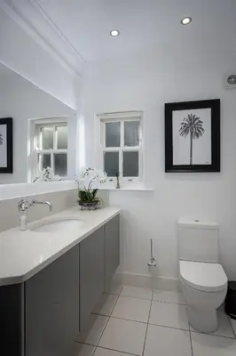 a bathroom with a sink and a toilet and two windows at Spengarth House by STAMP SA in Blackpool