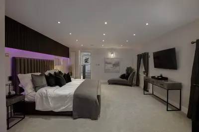 a large bedroom with a large bed and a television at Spengarth House by STAMP SA in Blackpool