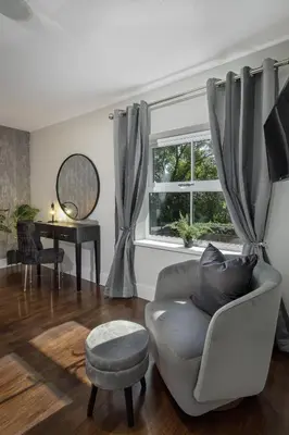 a living room with a chair and a window at Spengarth House by STAMP SA in Blackpool