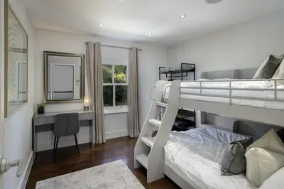 a bedroom with two bunk beds and a desk at Spengarth House by STAMP SA in Blackpool