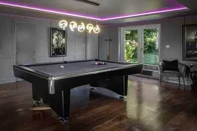 a billiard room with a pool table and purple lighting at Spengarth House by STAMP SA in Blackpool