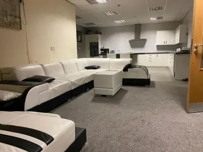 a large room with white leather couches in a room at ART APARTMENT in Fleetwood