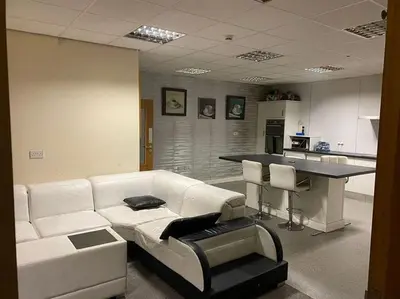 a living room with a white couch and a kitchen at ART APARTMENT in Fleetwood