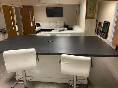 a large table in a room with two white chairs at ART APARTMENT in Fleetwood