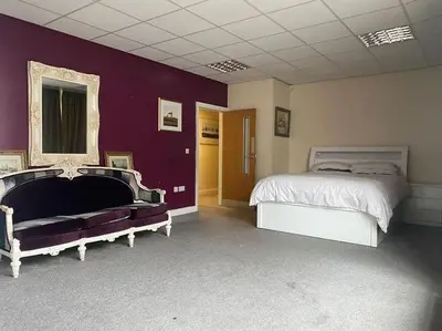 a bedroom with two beds and a purple wall at ART APARTMENT in Fleetwood
