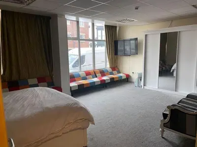 a room with a bed and a couch and a tv at ART APARTMENT in Fleetwood