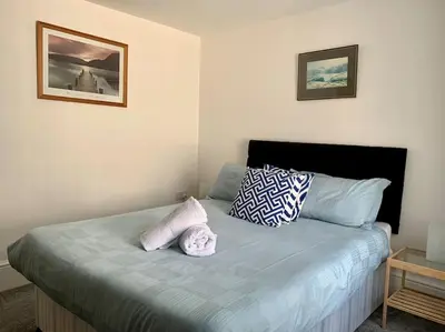 a bedroom with a bed with two pillows on it at Newly renovated 4 bedroom house in Ulverston in Ulverston